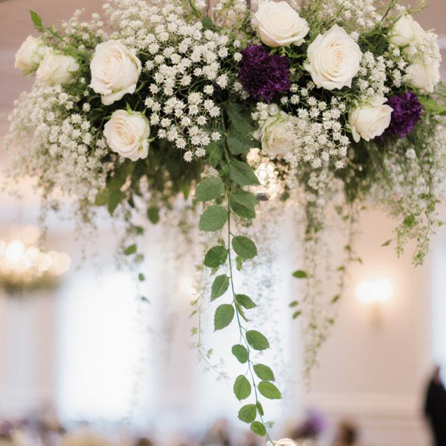 A 20-foot hanging floral chandelier with white orchids and greenery